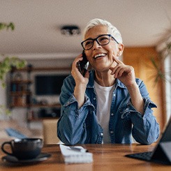 Woman smiling while talking on phone at home