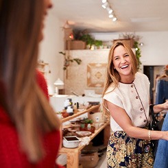 Woman smiling while shopping with friend in store