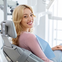 Patient smiling while sitting in treatment chair