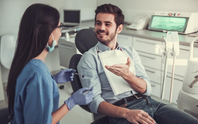 Dental patient talking to dentist about treatment options