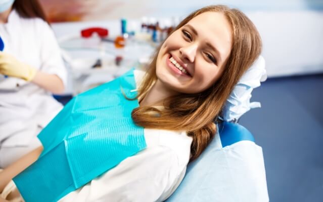Woman sharing smile during dental treatment