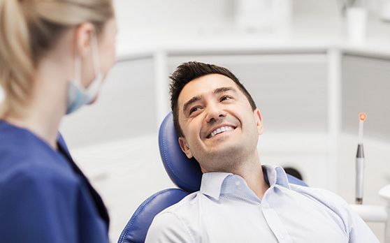 dentist talking to patient about dental crowns in Rockville