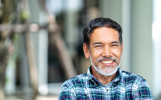 Man smiling with dental bridge in Rockville