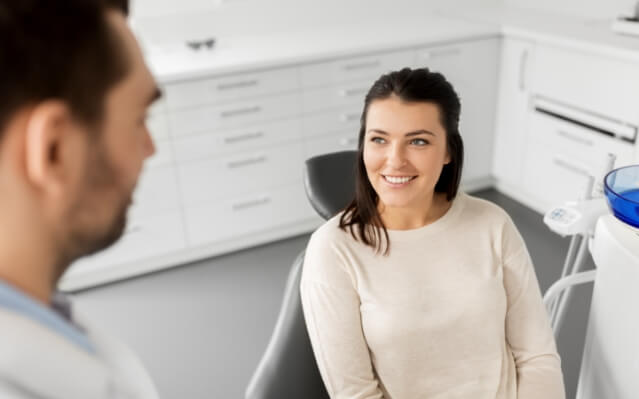 Dentist talking to dental patient