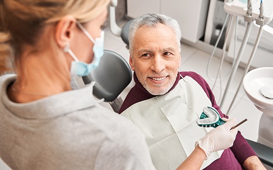 Implant Dentures patient in Rockville talking to dentist