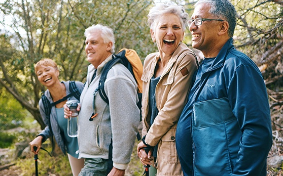Implant Dentures patient in Rockville smiling with friends