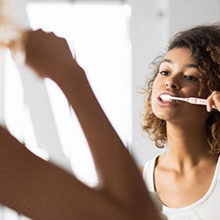  Patient in Rockville brushing their dental implants