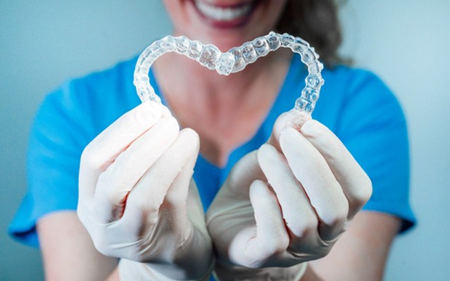 patient holding clear aligners 