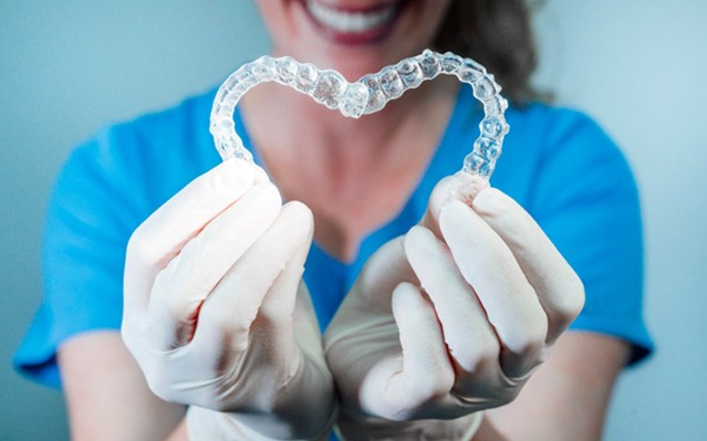 patient holding clear aligners