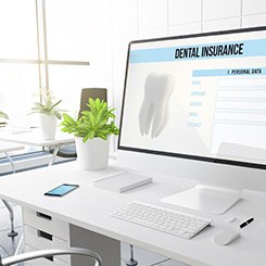 Dental insurance form on desktop in office
