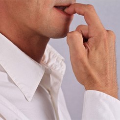 Close-up of nervous man biting his fingernails 