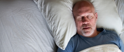 Man sleeping soundly thanks to sleep apnea therapy