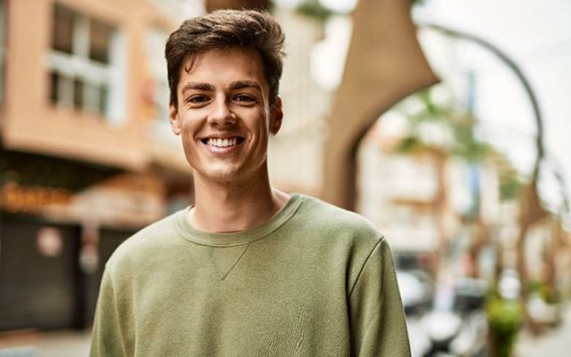 man smiling after getting veneers in Rockville