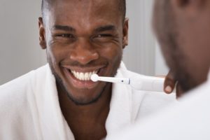 man with electric toothbrush