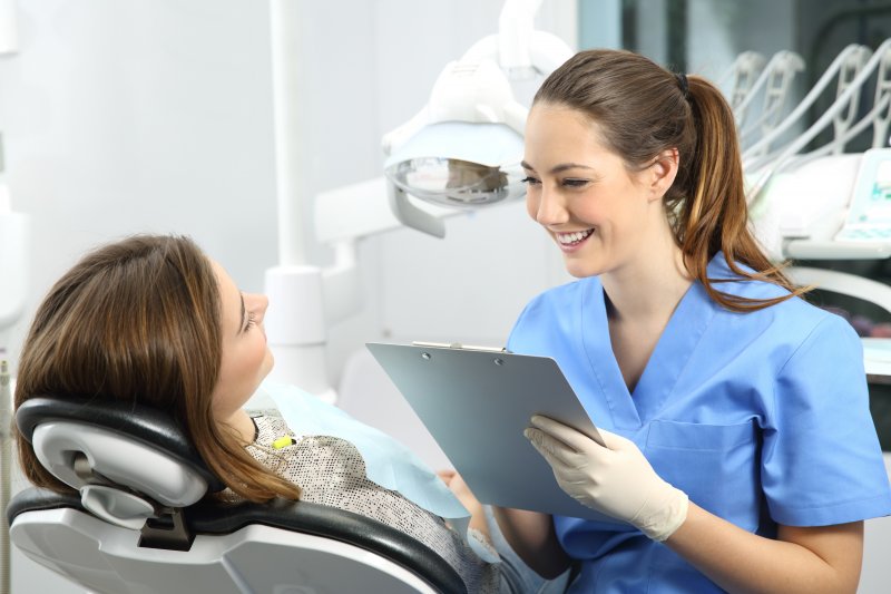 dentist talking to patient about kinds of dental crowns 