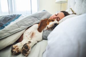 Woman sleeping with her dog
